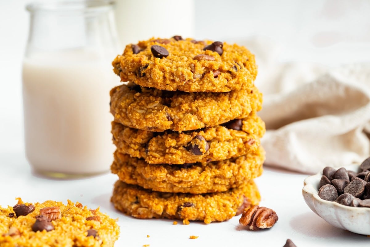 A stack of five sweet potato breakfast cookies with chocolate chips and pecans.