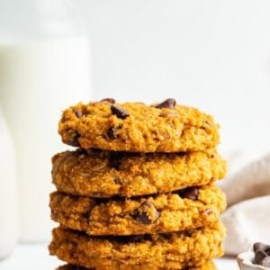 A stack of five sweet potato breakfast cookies with chocolate chips and pecans.