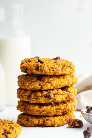 A stack of five sweet potato breakfast cookies with chocolate chips and pecans.