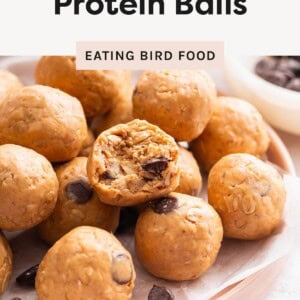 Close-up of peanut butter protein balls with chocolate chips, one cut open to show the inside.