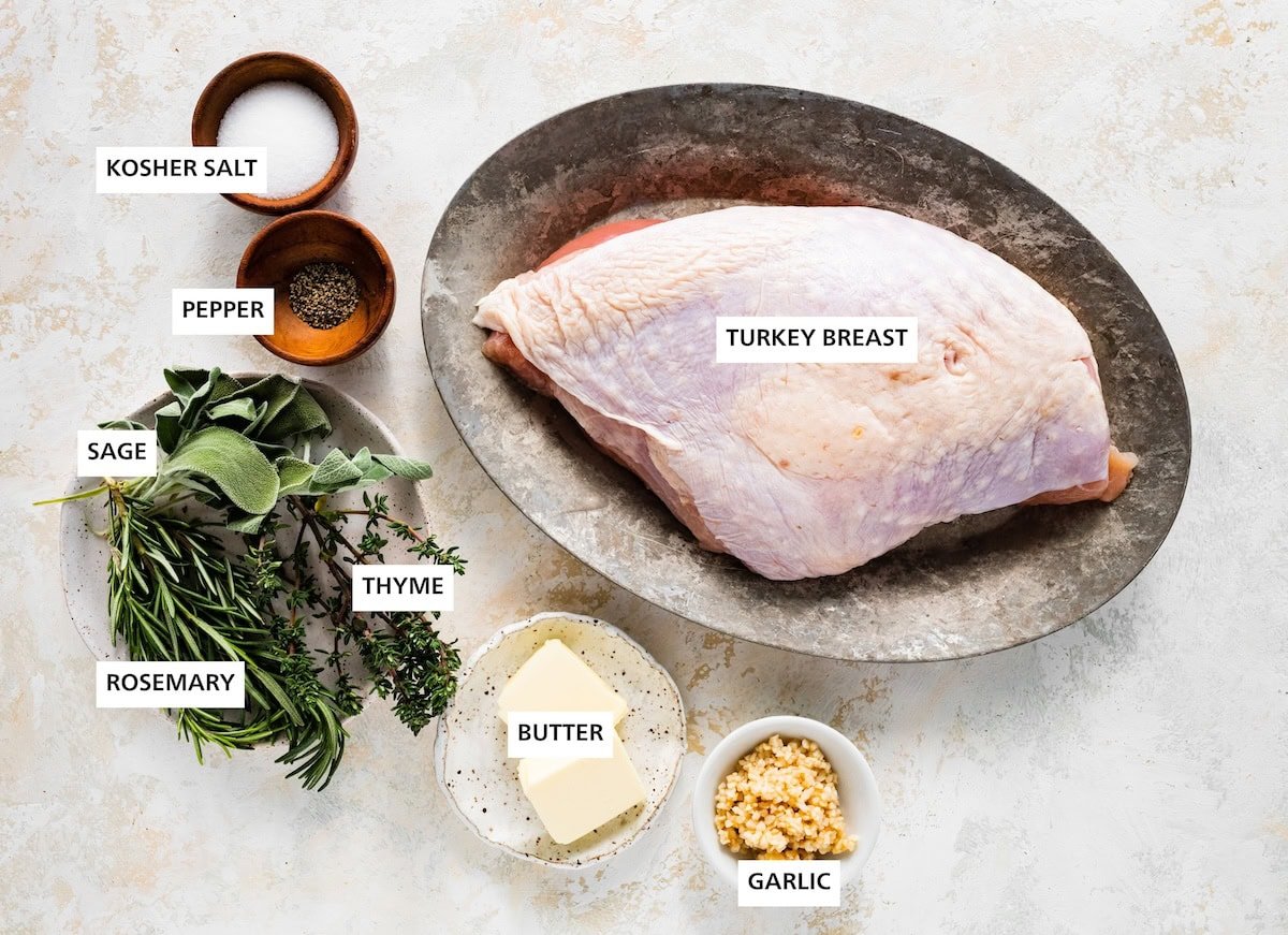 Ingredients measured out to make Air Fryer Turkey Breast: turkey breast, garlic, butter, thyme, sage, rosemary, kosher salt and pepper.