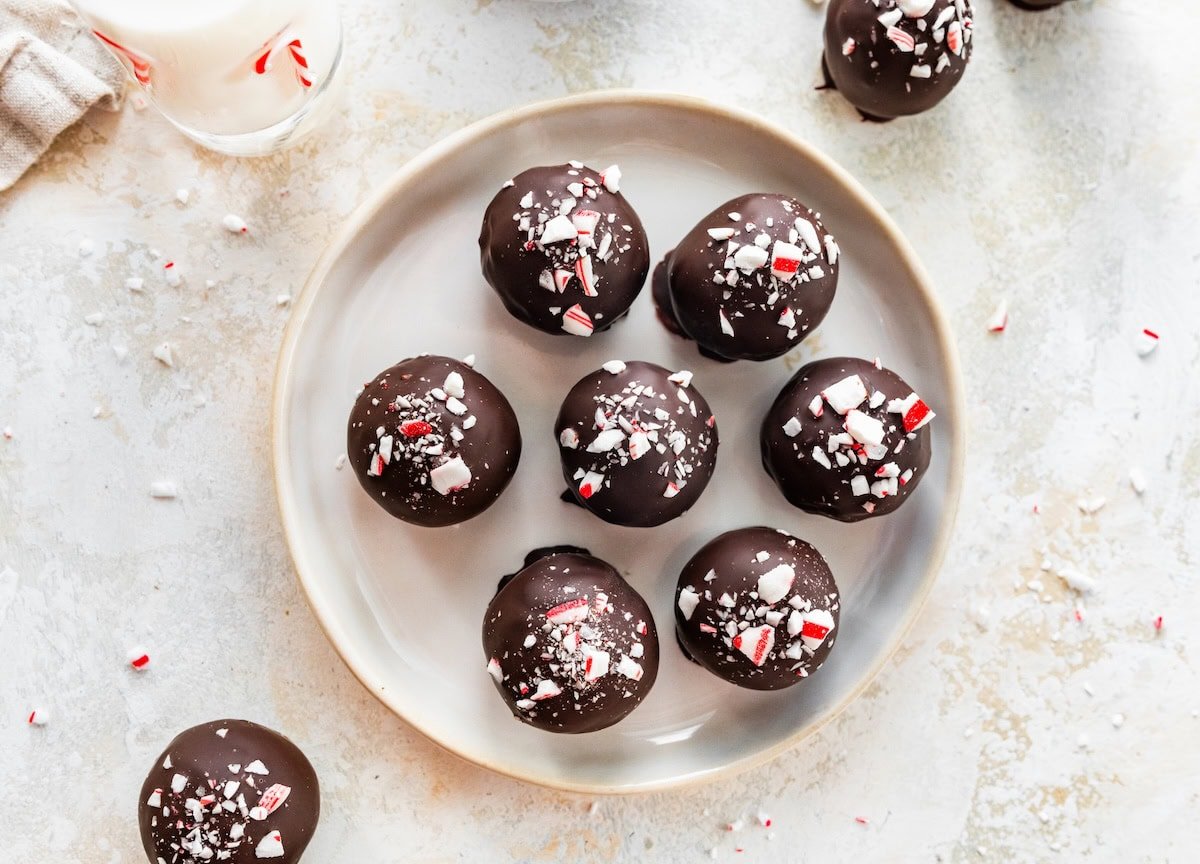 Close-up overhead shot of chocolate peppermint protein balls arranged on a plate.