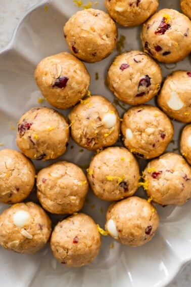 A white dish of cranberry orange protein balls.