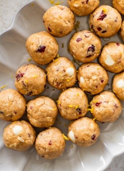A white dish of cranberry orange protein balls.
