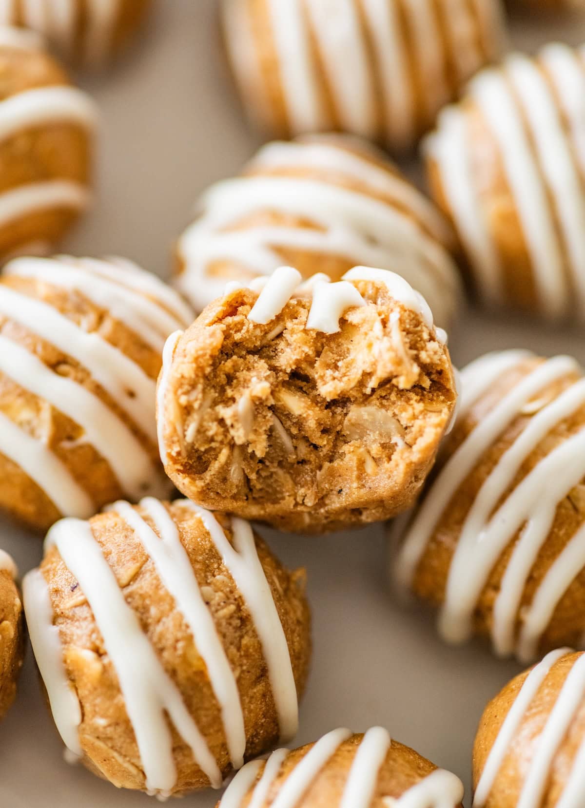 Close-up of a bitten gingerbread protein ball showing the soft, chewy texture inside.