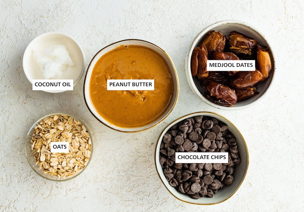 Ingredients measured out to make Healthy Peanut Butter Balls: medjool dates, chocolate chips, peanut butter, coconut oil and oats.