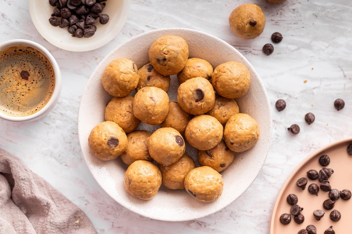 Overhead view of a full bowl of peanut butter protein balls ready for snacking.