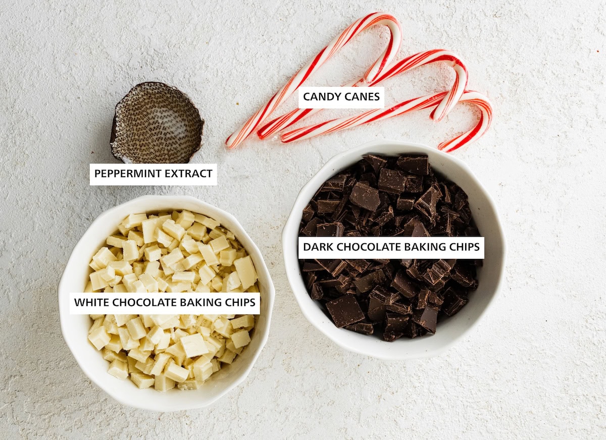 Ingredients measured out to make Peppermint Bark: candy canes, dark chocolate baking chips, white chocolate baking chips, peppermint extract.