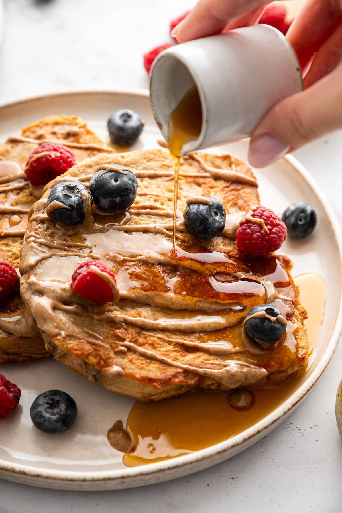 Protein French toast topped with berries and maple syrup drizzle.