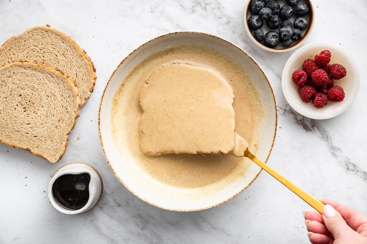 Single slice of bread coated in protein French toast batter.