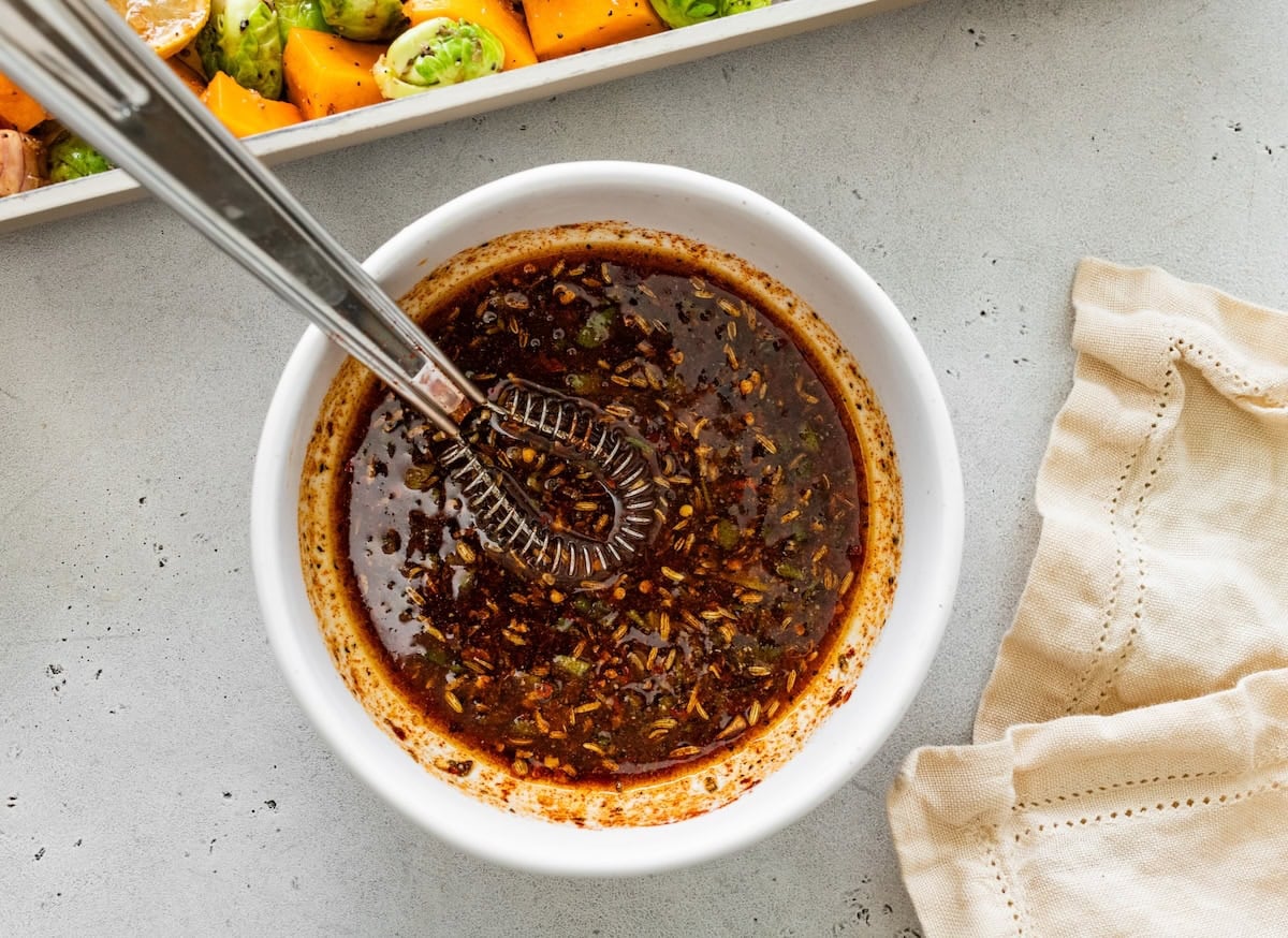 Marinade Marinade mixed together in a small white bowl for the chicken and veggies.