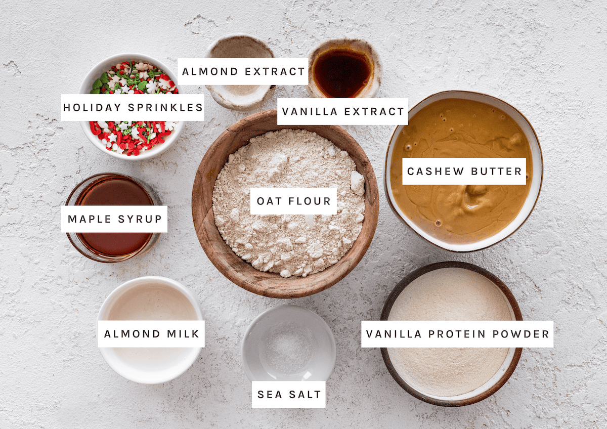 Oat flour, cashew butter, vanilla protein powder, maple syrup, almond milk, vanilla extract, almond extract, sea salt, holiday sprinkles