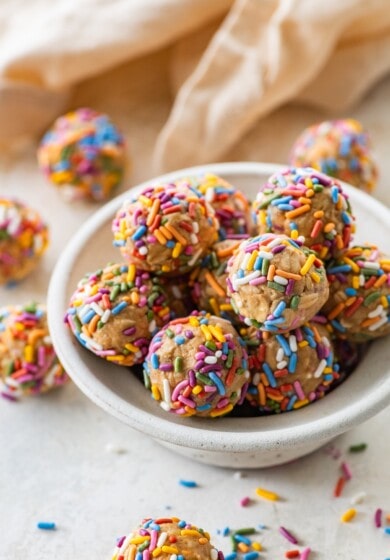 A bowl full of birthday cake protein balls with colorful sprinkles.