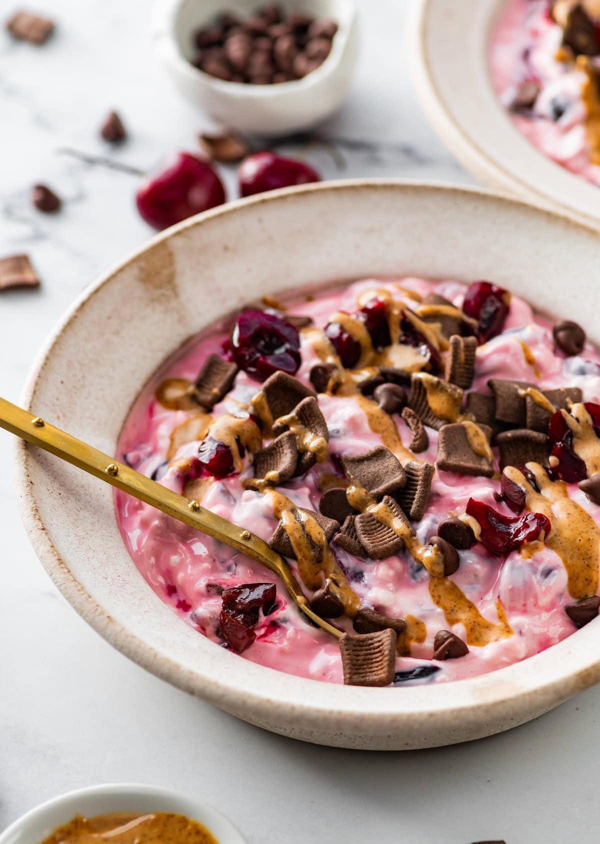 Finished chocolate cherry cheesecake yogurt bowl with chocolate cereal and almond butter.