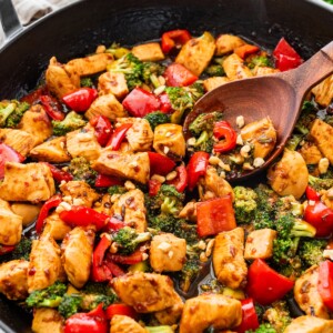 Kung pao chicken stir fry with vegetables and sauce in a skillet, ready to serve.