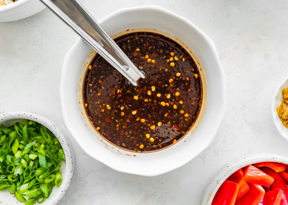 Kung pao sauce mixed in a bowl with soy sauce, honey, and chili paste.
