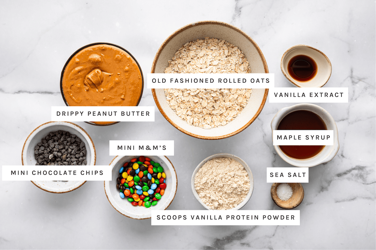 Drippy peanut butter, old fashioned rolled oats, vanilla extract, maple syrup, mini chocolate chips, mini M&M&rsquo;s, vanilla protein powder, sea salt