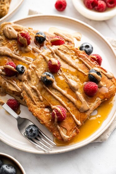 Protein French toast topped with peanut butter drizzle and fresh berries.
