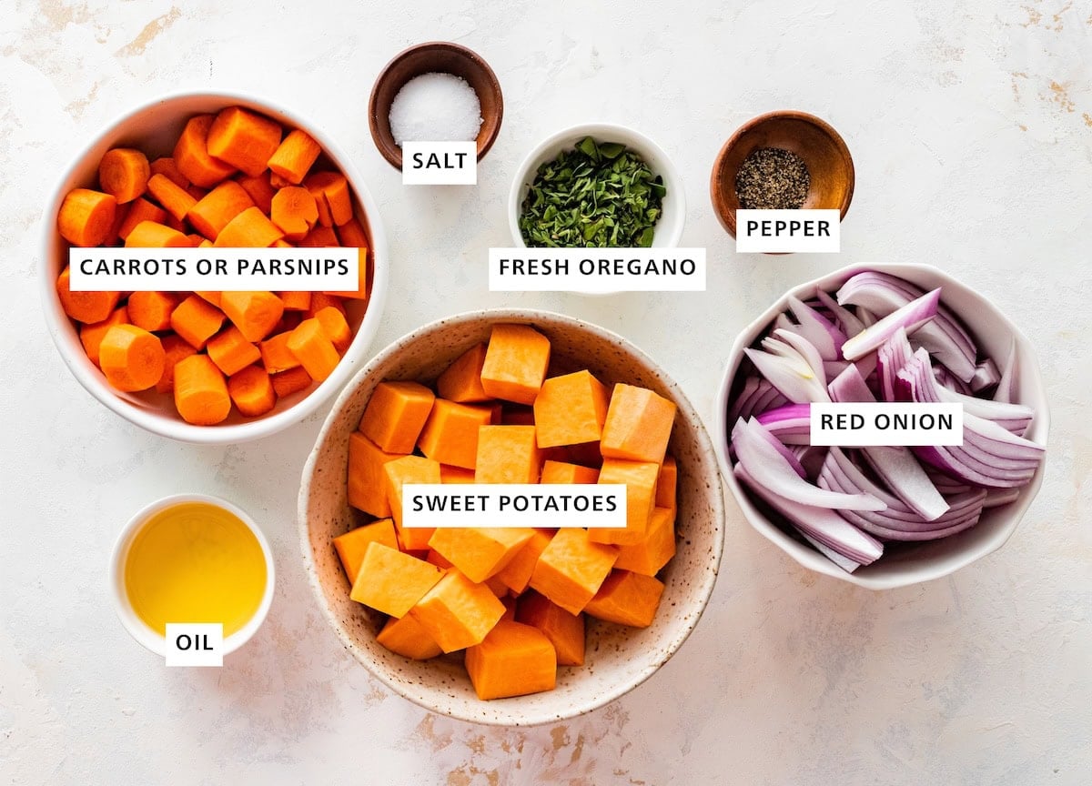 Ingredients measured out to make roasted root vegetables: oil, fresh oregano, pepper, parsnips, sweet potatoes, salt and red onion.