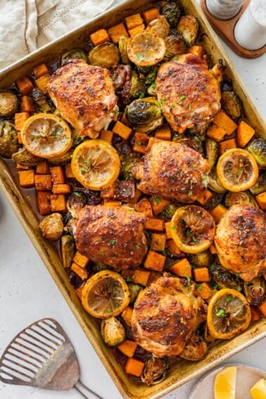 Sheet pan chicken and veggies with roasted Brussels sprouts, butternut squash, and lemon slices.