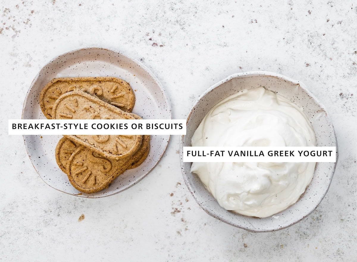 A bowl of full fat vanilla greek yogurt next to a small plate of biscuit cookies.