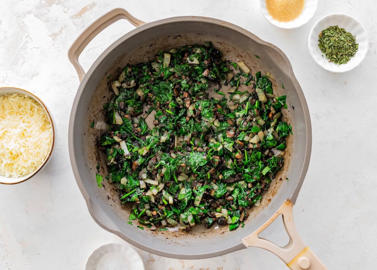 Cooked spinach mixture in skillet for baked cottage cheese eggs before adding egg mixture.
