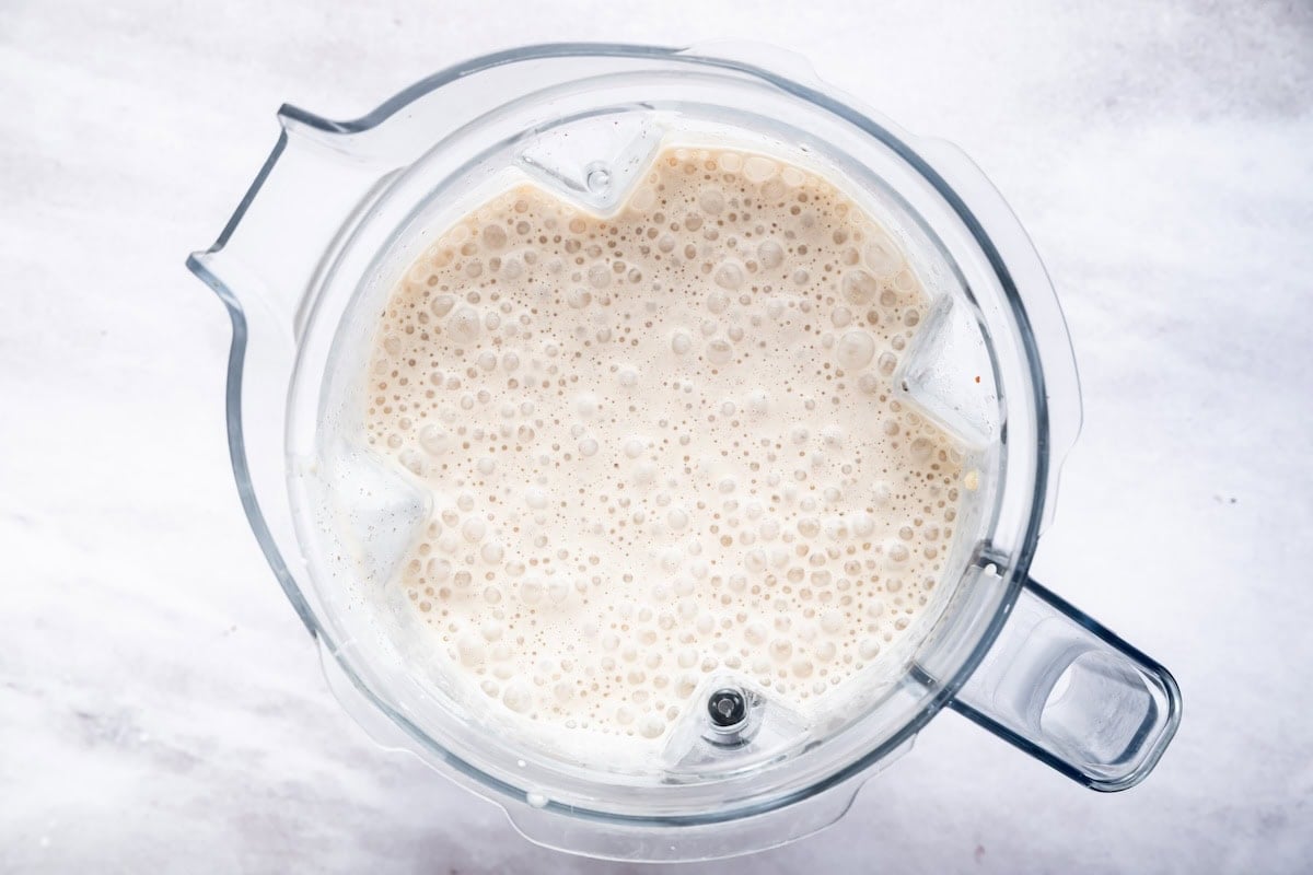 A blended cake batter protein shake in the base of a Vitamix blender.