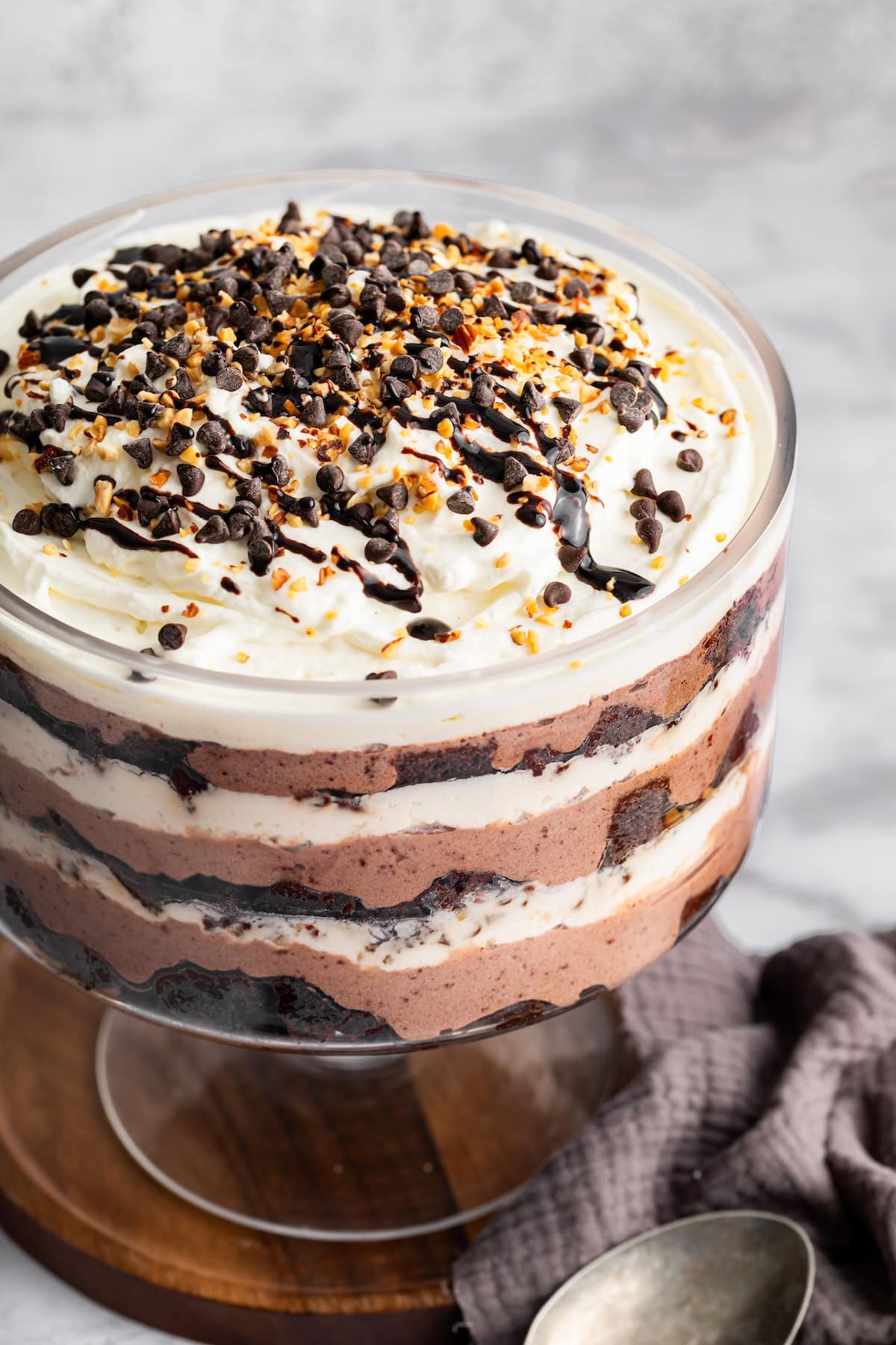 Completed high-protein chocolate trifle topped with whipped cream and chocolate drizzle.