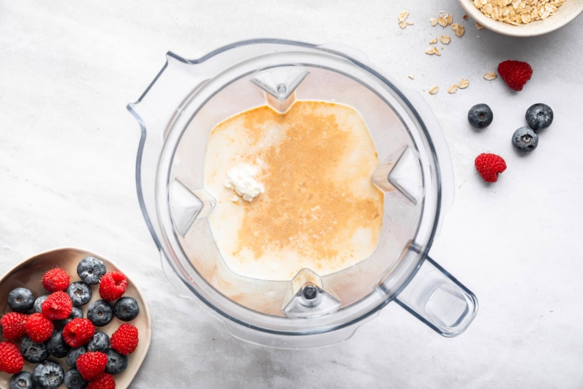 The wet ingredients for the cottage cheese baked oatmeal cups blended up in the base of a blender.