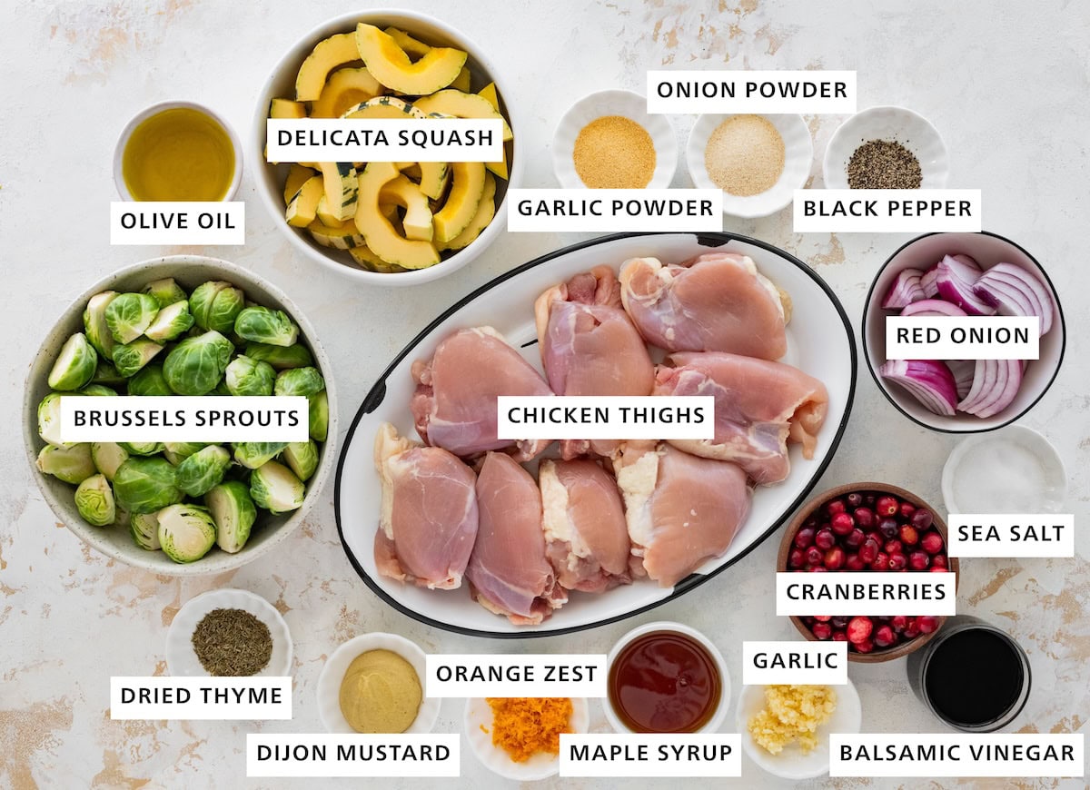 Delicata squash, Brussels sprouts, chicken thighs, red onion, cranberries, olive oil, garlic powder, onion powder, black pepper, sea salt, balsamic vinegar, garlic, maple syrup, orange zest, Dijon mustard, dried thyme.
