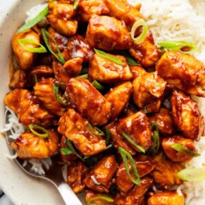 Sweet and savory glazed chicken served over fluffy rice in a bowl.