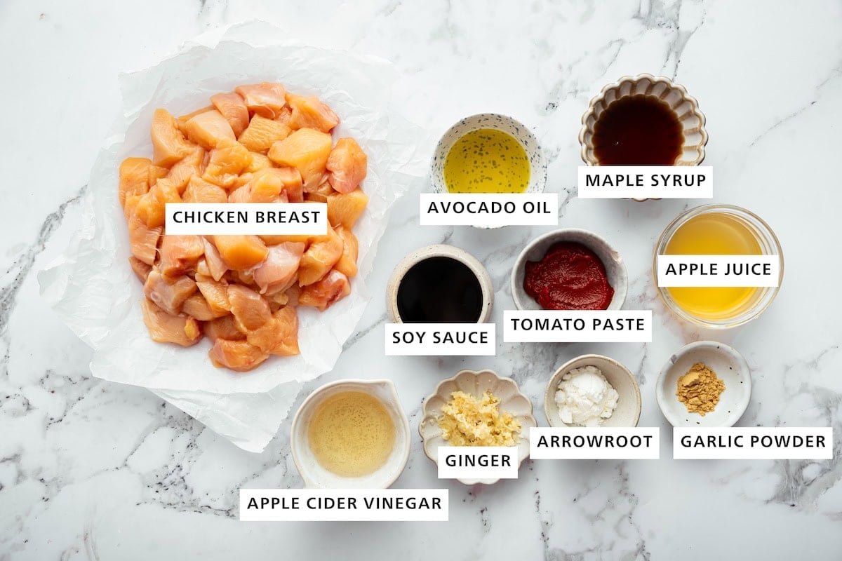 Ingredients for glazed chicken recipe: chicken breast, avocado oil, maple syrup, apple juice, tomato paste, soy sauce, apple cider vinegar, ginger, arrowroot and garlic powder.