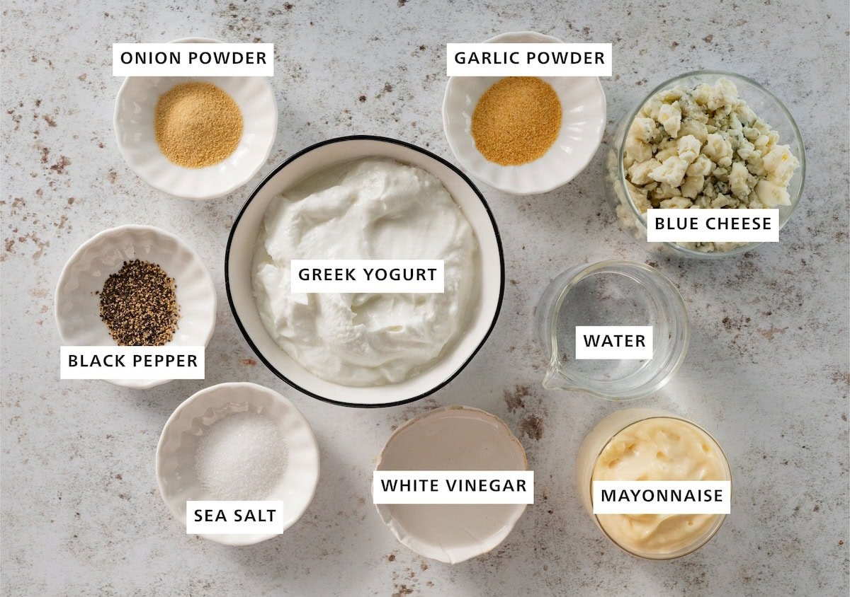 Ingredients for greek yogurt blue cheese dressing including greek yogurt, blue cheese, mayonnaise, white vinegar, sea salt, blackk pepper, onion powder, garlic powder, and water.
