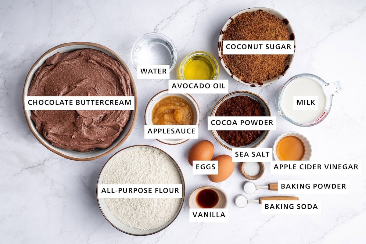 Ingredients used for healthy chocolate cupcakes includes: almond milk, coconut sugar, chocolate buttercream, water, avocado oil, applesauce, flour, eggs, vanilla, baking soda, baking powder, vinegar, salt, and cocoa powder.