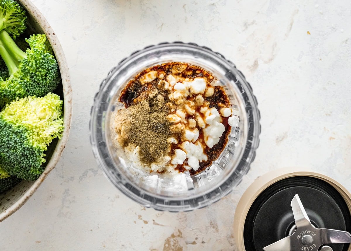 A bullet blender with cottage cheese, tamari, and seasonings.
