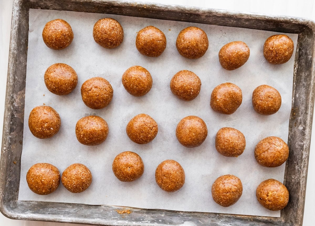 Banana bread protein balls on a parchment-lined baking sheet.