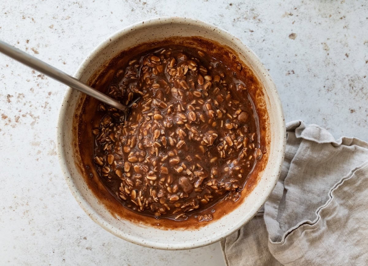 A large mixing bowl of chocolate overnight oats used for cadbury mini egg overnight oats.