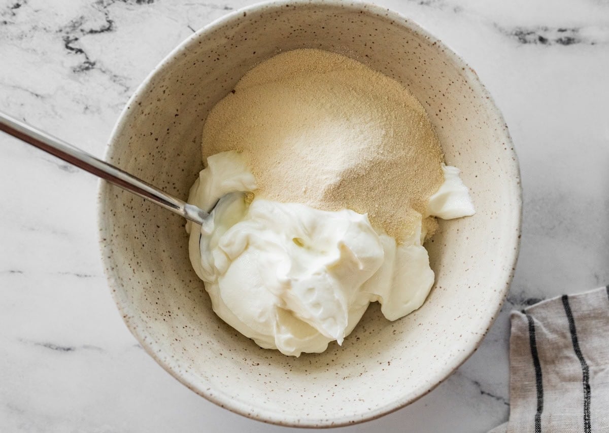 A large mixing bowl with Greek yogurt and vanilla protein powder.