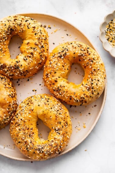 Close up of golden cottage cheese bagels topped with everything seasoning.