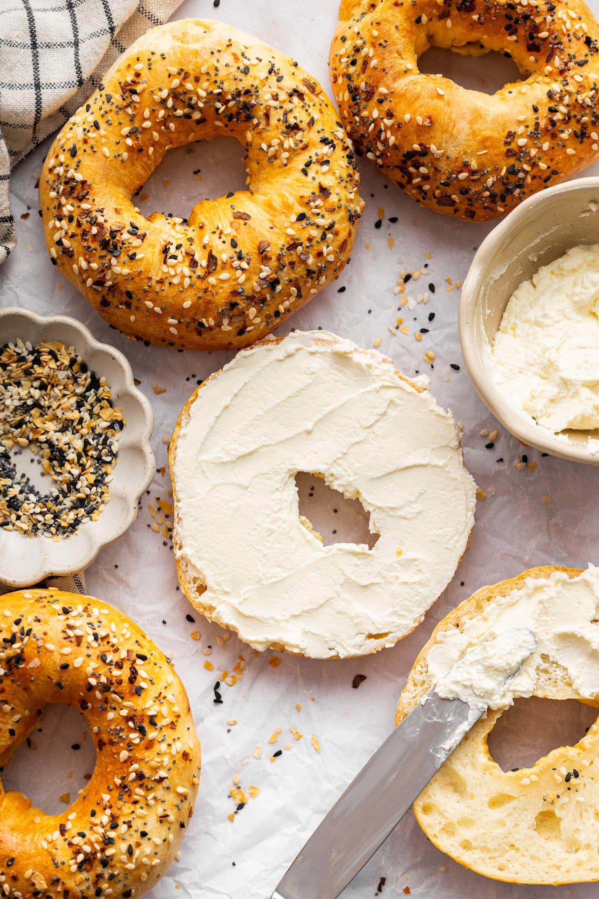 Cottage cheese bagels sliced and served with cream cheese on a light surface.