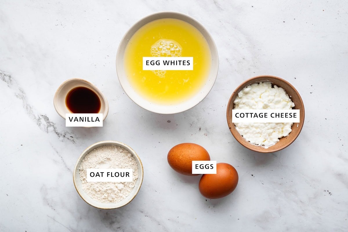 Ingredients measured out for protein crepes: egg whites, cottage cheese, eggs, oat flour, and vanilla.