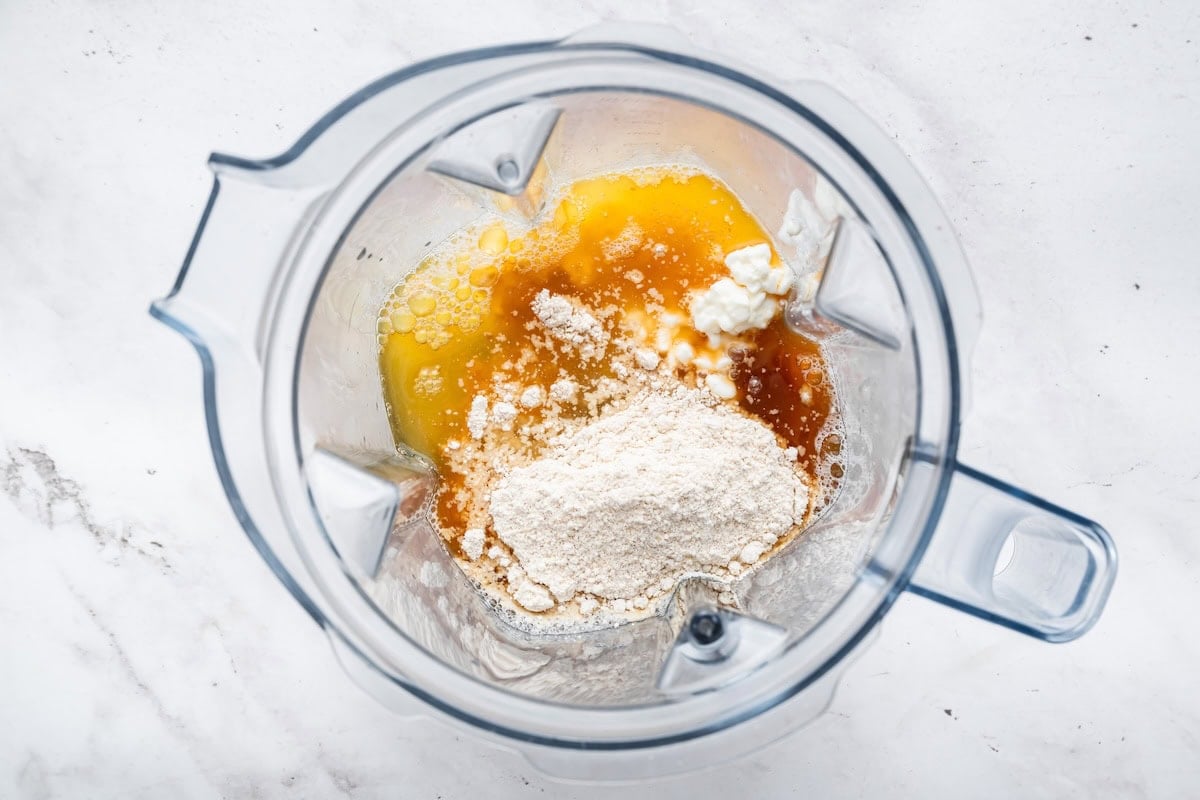A blender with oat flour, eggs, egg whites, cottage cheese, and vanilla.