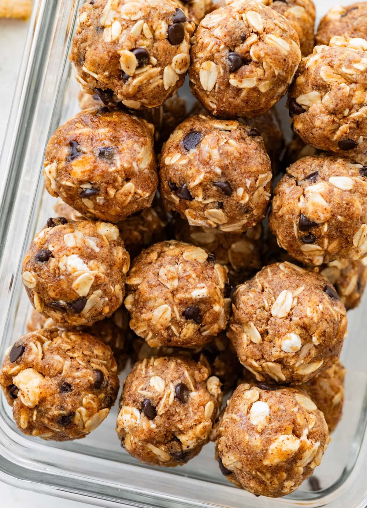 S&rsquo;mores protein balls stacked in a glass storage container.