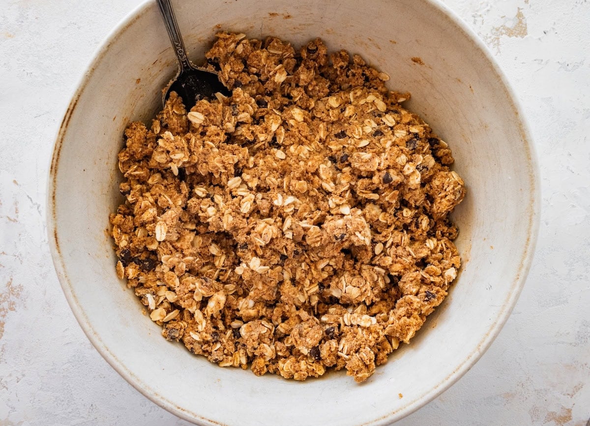 Mixing s&rsquo;mores protein ball dough in a white mixing bowl.