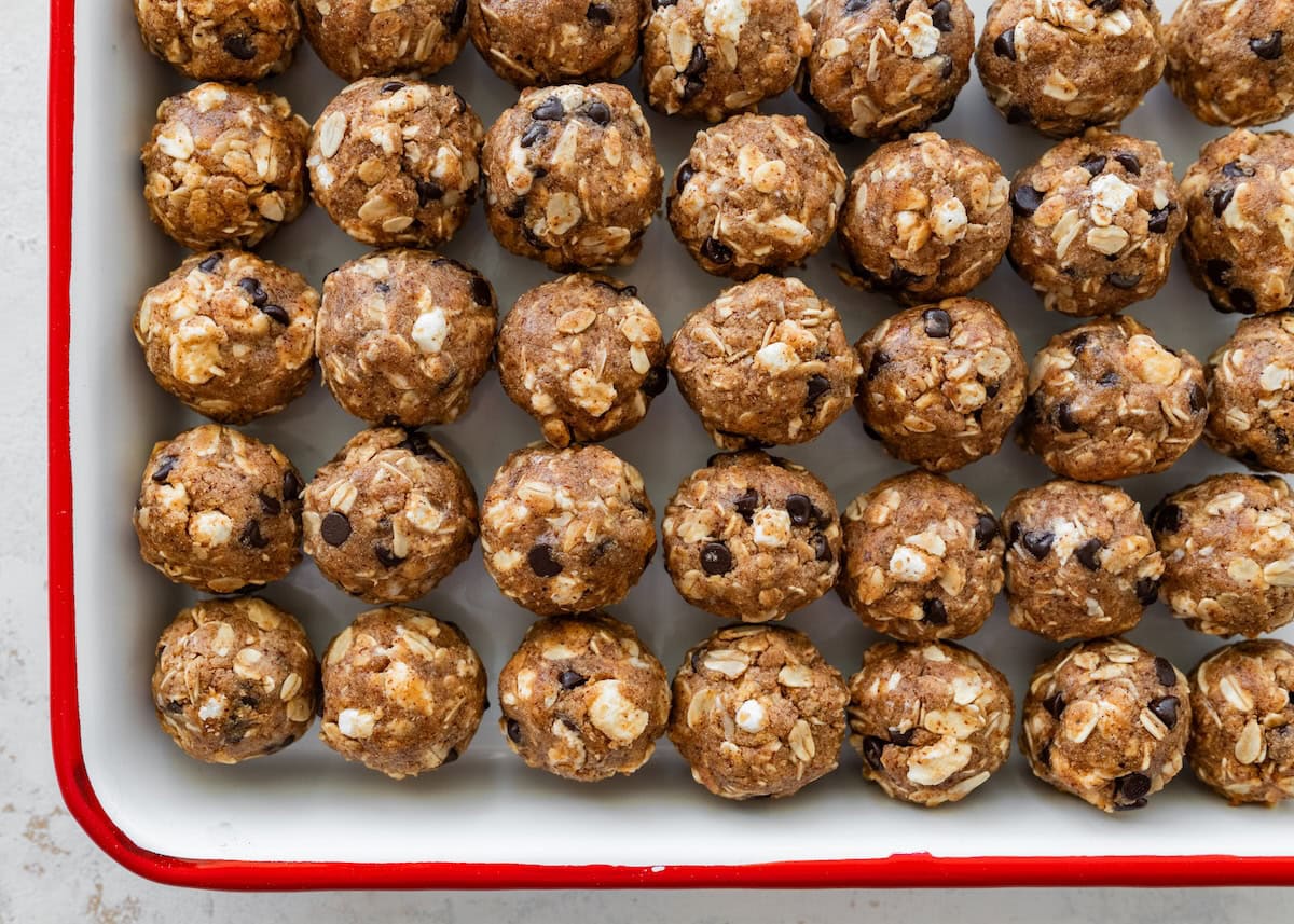 Batch of s&rsquo;mores protein balls lined up on a baking sheet.