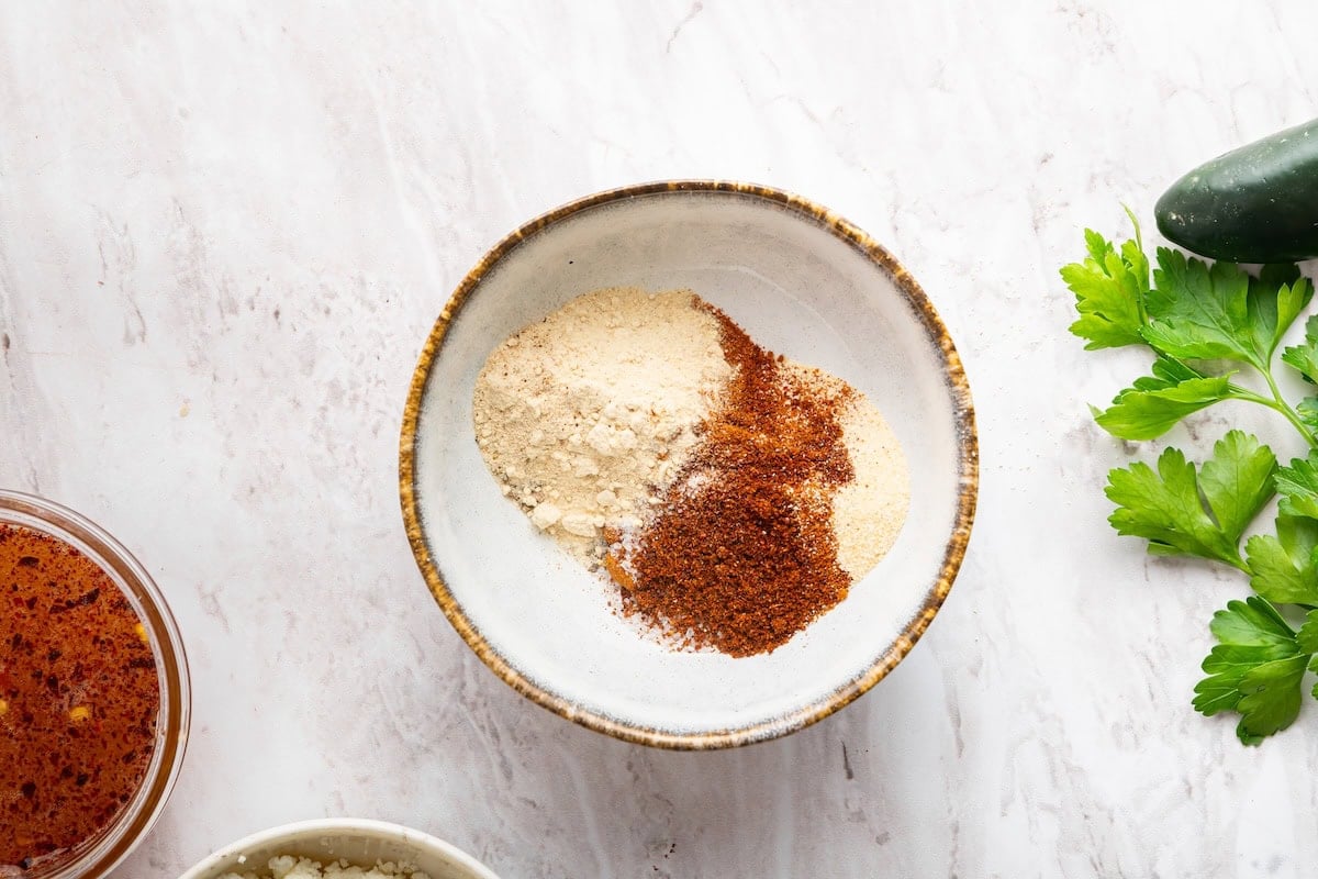 A small dish with multiple spices.