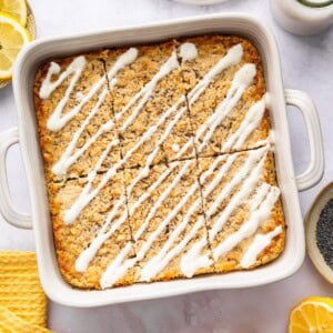Lemon poppy seed baked oatmeal in pan drizzled with yogurt glaze ready to serve.