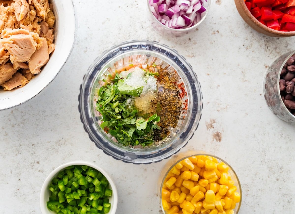 Ingredients used to make a sauce for Mexican tuna salad in a blender before being mixed.