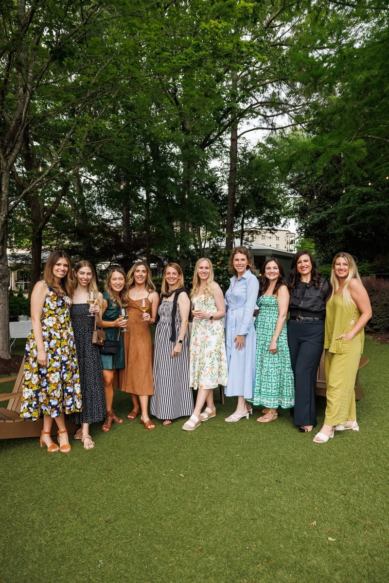 A group of food bloggers posing together outside during an Atlanta event.