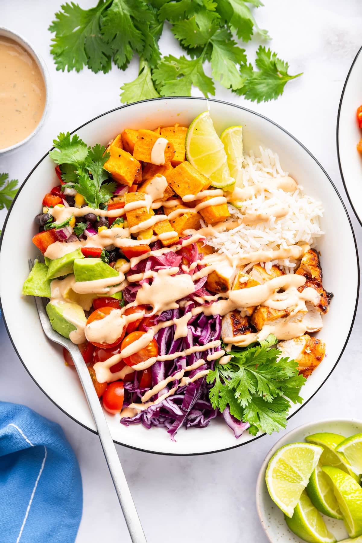A serving of a BBQ chicken bowl with a drizzle of BBQ ranch dressing.